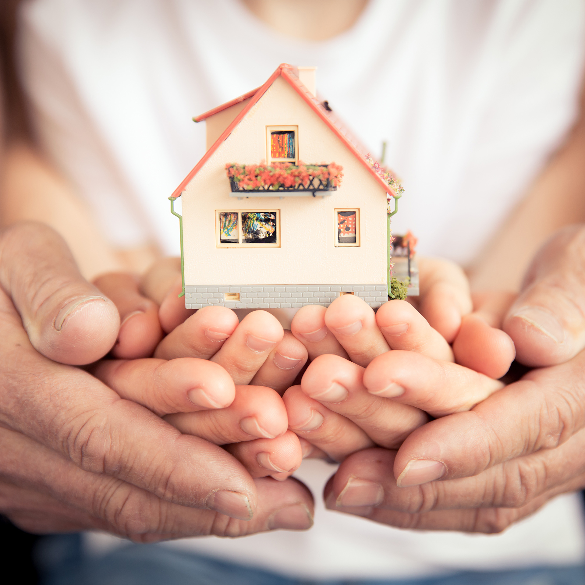 Family holding house in hands Family holding house in hands. Moving and spring renovation concept